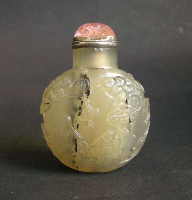 Agate snuff bottle sculpted with scholar and servant in landscape on a face, other with figure in a boat